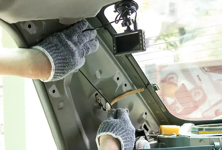 Someone installing a dashcam