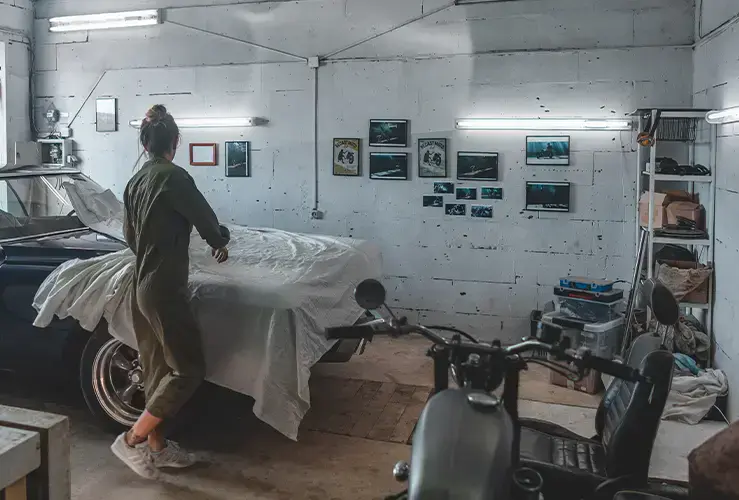 A covered up car in a garage