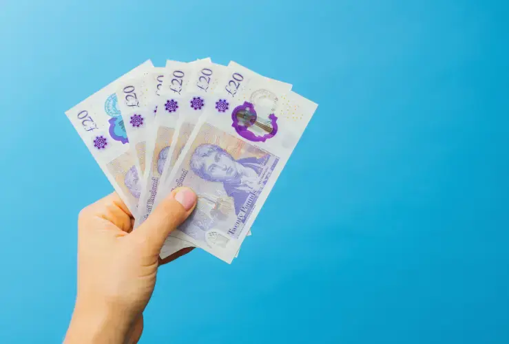 A person holding some &pound;20 notes