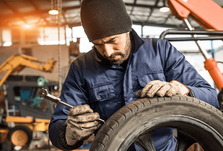 A mechanic working on a tyre