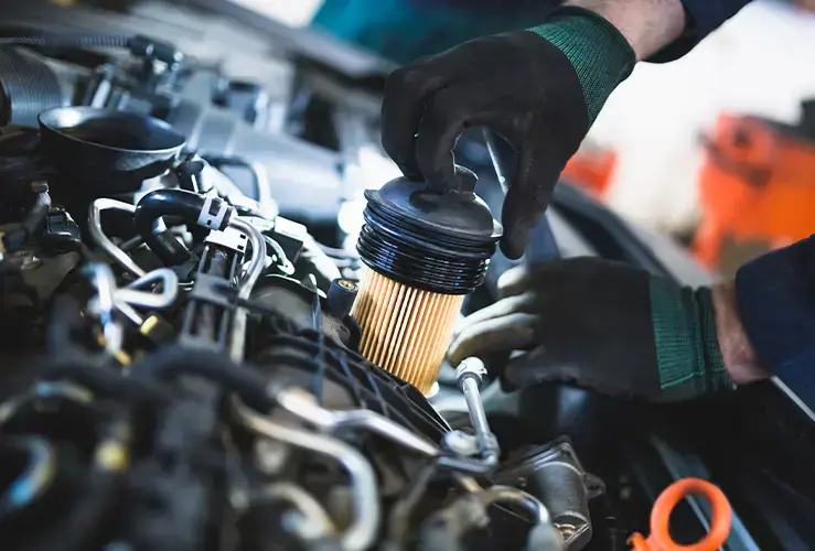 Close up of hands working on a car's engine