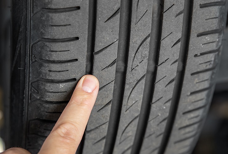 mechanic pointing at tyre tread