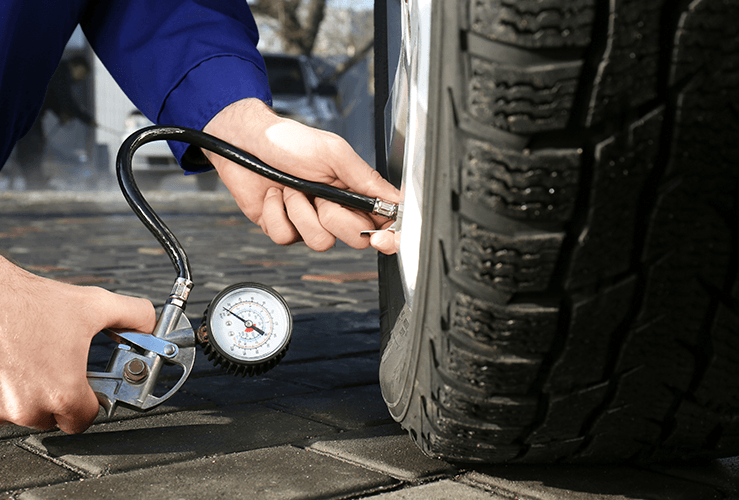 Person checking tyre pressure