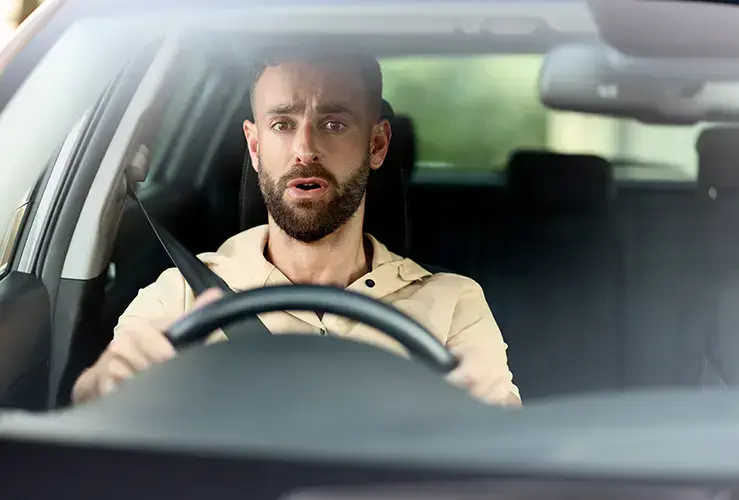 A man looking sad in a car