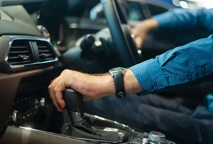 A hand on a car gear stick