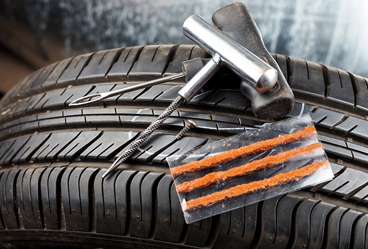 Flat tyre repair kit on top of a tyre