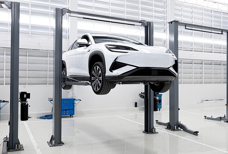 Raised electric vehicle in a garage