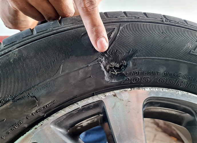 tyre wall that has been torn by sharp object