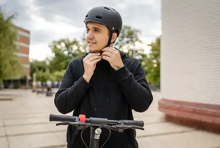 A person putting on a helmet