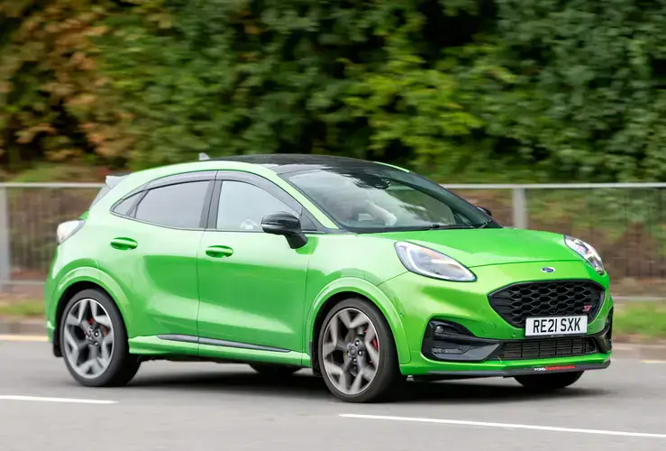 Green Ford Puma driving on British road